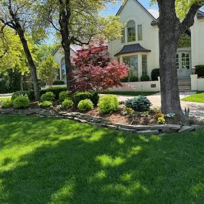 nicely landscaped home with green healthy lawn