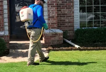 lawn care technician spraying yard